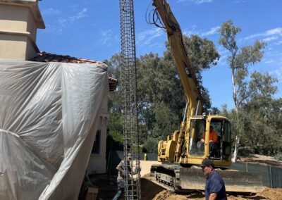 Crane setting up a rebar spiral frame.